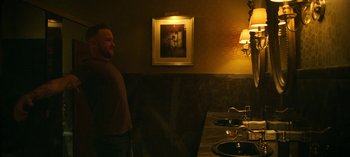 A man standing next to a bathroom sink