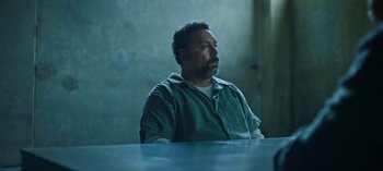 Movie still from “Ozark” (2017), created by Bill Dubuque – A man sitting at a table in a jail cell; Medium shot, High angle