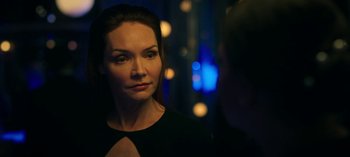 Movie still from “Ozark” (2017), created by Bill Dubuque – A woman in a black dress is looking at the camera; Close Up shot, Over the shoulder angle