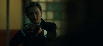 Movie still from “Ozark” (2017), created by Bill Dubuque – A man in a suit and tie holding a gun; Close Up shot, Low angle