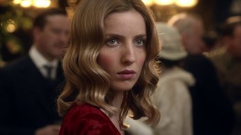 Movie still from “Peaky Blinders” (2013), created by Steven Knight – A person with long hair; Close Up shot, Over the shoulder angle