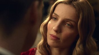 Movie still from “Peaky Blinders” (2013), created by Steven Knight – A person wearing a red dress; Close Up shot, Over the shoulder angle