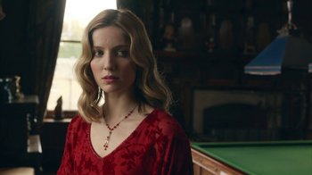 Movie still from “Peaky Blinders” (2013), created by Steven Knight – A woman in a red dress standing next to a pool table; Close Up shot, Over the shoulder angle