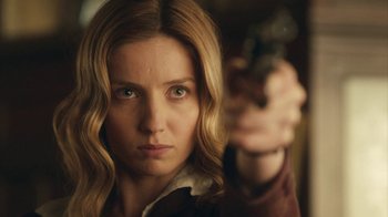 Movie still from “Peaky Blinders” (2013), created by Steven Knight – A woman holding a gun in her right hand; Close Up shot, Over the shoulder angle