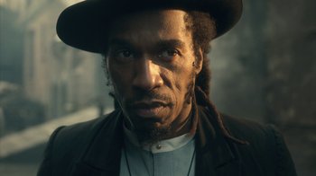 Movie still from “Peaky Blinders” (2013), created by Steven Knight – A person wearing a hat; Close Up shot, Low angle