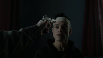 Movie still from “Mr. Robot” (2015), created by Sam Esmail – A man with bandages on his head and a gun pointed at him; Close Up shot, Low angle