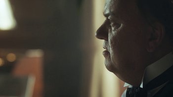 Movie still from “Peaky Blinders” (2013), created by Steven Knight – A man's face in the sunlight; Close Up shot, Low angle