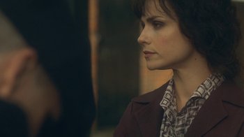 Movie still from “Peaky Blinders” (2013), created by Steven Knight – A person wearing a jacket; Close Up shot, Over the shoulder angle