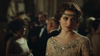 Movie still from “Peaky Blinders” (2013), created by Steven Knight – A beautiful woman in a dress and a headband; Close Up shot, Over the shoulder angle