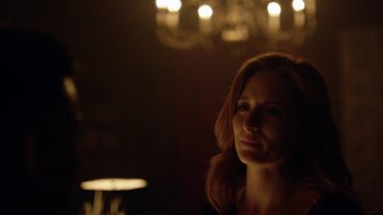 Movie still from “Mr. Robot” (2015), created by Sam Esmail – A woman with long red hair standing in front of a chandelier; Close Up shot, Over the shoulder angle