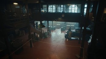 Movie still from “Peaky Blinders” (2013), created by Steven Knight – A man sitting on a chair in a room; Extreme Wide shot, High angle