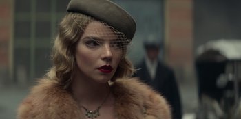 Movie still from “Peaky Blinders” (2013), created by Steven Knight – A woman wearing a hat and a fur coat; Close Up shot, Low angle