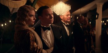 Movie still from “Peaky Blinders” (2013), created by Steven Knight – A group of people standing next to each other in a room; Medium shot, Low angle