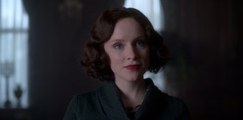 Movie still from “Peaky Blinders” (2013), created by Steven Knight – A person with short hair; Close Up shot, Over the shoulder angle