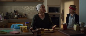 Movie still from “Penguin Bloom” (2020), directed by Glendyn Ivin – A woman sitting at a table with a plate of food; Medium shot, Over the shoulder angle