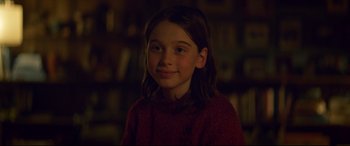 Movie still from “Penguin Bloom” (2020), directed by Glendyn Ivin – A young girl in a red sweater is smiling for the camera; Close Up shot, Over the shoulder angle