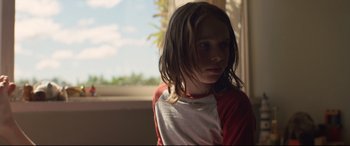 Movie still from “Penguin Bloom” (2020), directed by Glendyn Ivin – A young girl with long brown hair wearing a red and white shirt; Close Up shot, Low angle