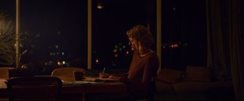 Movie still from “Penguin Bloom” (2020), directed by Glendyn Ivin – A woman sitting at a table writing on a piece of paper; Medium shot, Over the shoulder angle