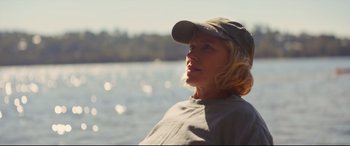 Movie still from “Penguin Bloom” (2020), directed by Glendyn Ivin – A woman wearing a hat looking out over a body of water; Close Up shot, Low angle