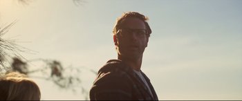 Movie still from “Penguin Bloom” (2020), directed by Glendyn Ivin – A person wearing glasses and a plaid shirt; Close Up shot, Low angle