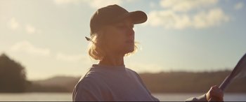 Movie still from “Penguin Bloom” (2020), directed by Glendyn Ivin – A woman wearing a baseball cap looking into the distance; Close Up shot, Low angle