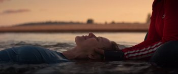 Movie still from “Penguin Bloom” (2020), directed by Glendyn Ivin – A man laying in the water with his eyes closed; Close Up shot, Over the shoulder angle