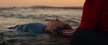 Movie still from “Penguin Bloom” (2020), directed by Glendyn Ivin – A man laying in the water next to another man; Medium shot, Over the shoulder angle