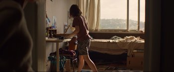 Movie still from “Penguin Bloom” (2020), directed by Glendyn Ivin – A woman standing at a table in a room; Wide shot, Over the shoulder angle