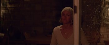 Movie still from “Penguin Bloom” (2020), directed by Glendyn Ivin – A woman wearing a white sweater standing in front of a door; Medium shot, Over the shoulder angle