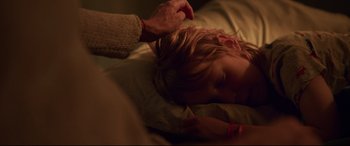 Movie still from “Penguin Bloom” (2020), directed by Glendyn Ivin – A child laying on a bed with an adult touching her hair; Close Up shot, Over the shoulder angle