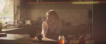Movie still from “Penguin Bloom” (2020), directed by Glendyn Ivin – A woman sitting at a table with a cup of coffee; Medium shot, Over the shoulder angle