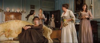 Movie still from “Pride & Prejudice” (2005), directed by Joe Wright – A group of people in period dress in a living room; Wide shot, High angle