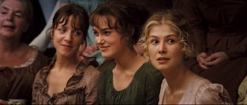 Movie still from “Pride & Prejudice” (2005), directed by Joe Wright – Three young women sitting next to each other in a row; Close Up shot, High angle