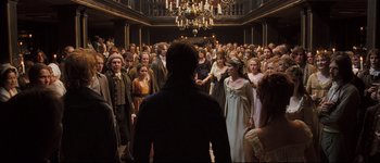 Movie still from “Pride & Prejudice” (2005), directed by Joe Wright – A group of people standing in a large room; Wide shot, High angle