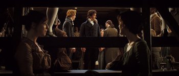 Movie still from “Pride & Prejudice” (2005), directed by Joe Wright – A group of people standing next to each other in a room; Wide shot, Over the shoulder angle