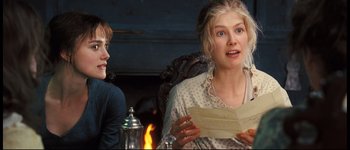 Movie still from “Pride & Prejudice” (2005), directed by Joe Wright – Two people sitting in front of a fireplace holding papers; Close Up shot, Over the shoulder angle