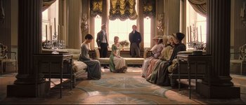 Movie still from “Pride & Prejudice” (2005), directed by Joe Wright – A group of people sitting in front of a large window; Wide shot, High angle