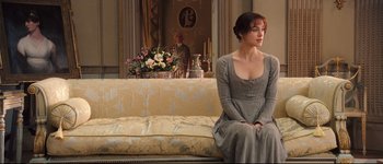 Movie still from “Pride & Prejudice” (2005), directed by Joe Wright – A woman sitting on top of a couch in front of a mirror; Wide shot, Over the shoulder angle