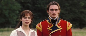 Movie still from “Pride & Prejudice” (2005), directed by Joe Wright – A man and a woman standing next to each other in front of trees; Close Up shot, Over the shoulder angle