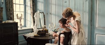 Movie still from “Pride & Prejudice” (2005), directed by Joe Wright – A woman and a child are sitting in front of a mirror; Medium shot, Over the shoulder angle
