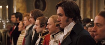 Movie still from “Pride & Prejudice” (2005), directed by Joe Wright – A group of people in historical clothing standing next to each other; Close Up shot, Over the shoulder angle
