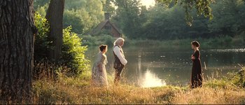 Movie still from “Pride & Prejudice” (2005), directed by Joe Wright – A man and a woman standing next to a body of water; Wide shot, High angle
