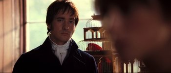 Movie still from “Pride & Prejudice” (2005), directed by Joe Wright – A man standing in front of a bird cage; Close Up shot, Over the shoulder angle