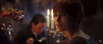 Movie still from “Pride & Prejudice” (2005), directed by Joe Wright – A woman with red hair standing in front of candles; Close Up shot, Over the shoulder angle