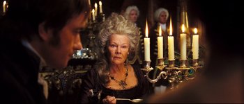 Movie still from “Pride & Prejudice” (2005), directed by Joe Wright – An older woman in a black dress with a long white wig; Close Up shot, Over the shoulder angle