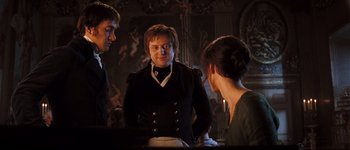Movie still from “Pride & Prejudice” (2005), directed by Joe Wright – A man and two women standing next to each other in a room; Medium shot, Over the shoulder angle
