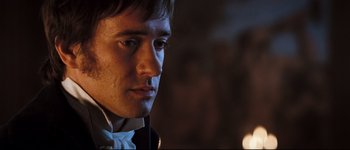 Movie still from “Pride & Prejudice” (2005), directed by Joe Wright – A person wearing a suit and tie; Close Up shot, Over the shoulder angle