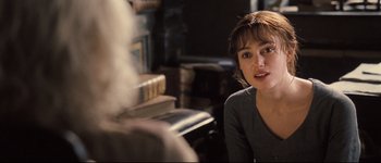 Movie still from “Pride & Prejudice” (2005), directed by Joe Wright – A woman sitting in front of a fireplace; Close Up shot, Over the shoulder angle