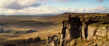 Movie still from “Pride & Prejudice” (2005), directed by Joe Wright – A man standing on top of a rock cliff; Extreme Wide shot, High angle