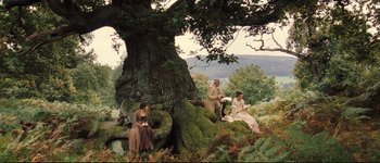 Movie still from “Pride & Prejudice” (2005), directed by Joe Wright – A group of people sitting under a large tree; Extreme Wide shot, High angle